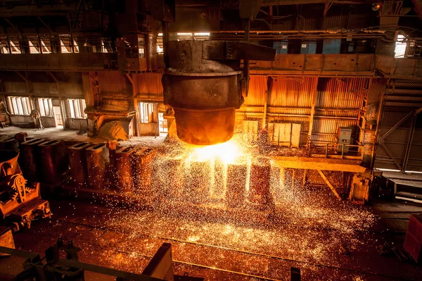 Steel mill with molten metal pouring operations